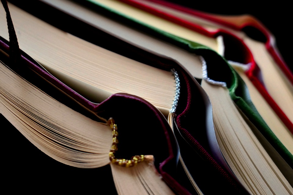 Several piled up opened books.