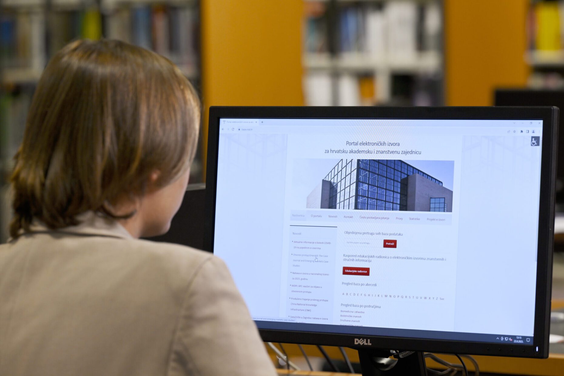 NSK user sitting at a laptop computer whose screen is showing the homepage of the NSK’s e-resources website.