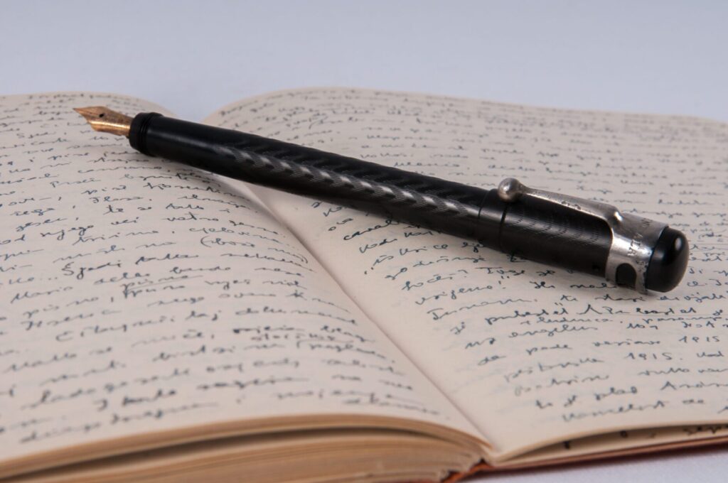 A fountain pen resting on an open notebook.