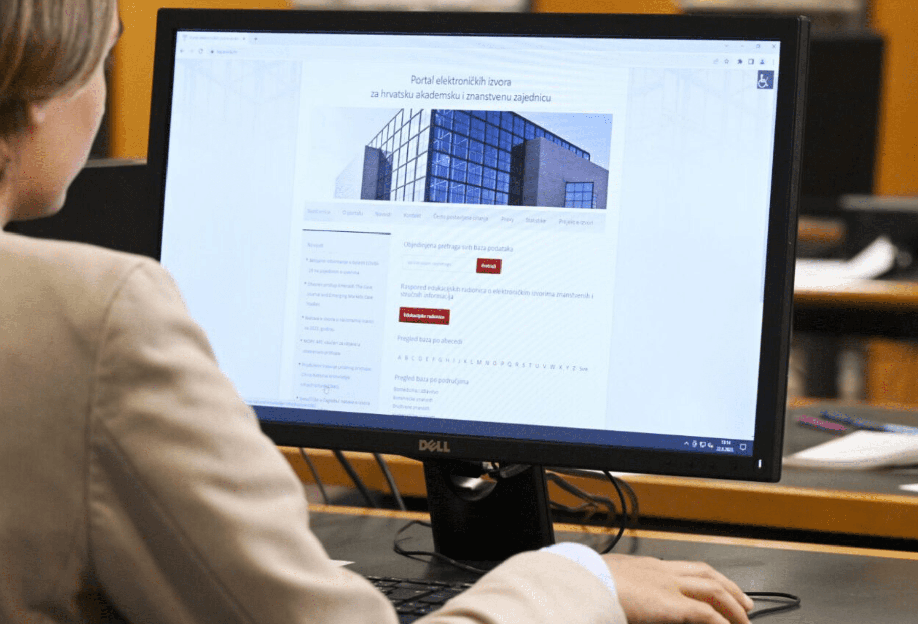 NSK user sitting at a laptop computer whose screen is showing the homepage of the NSK’s e-resources website.