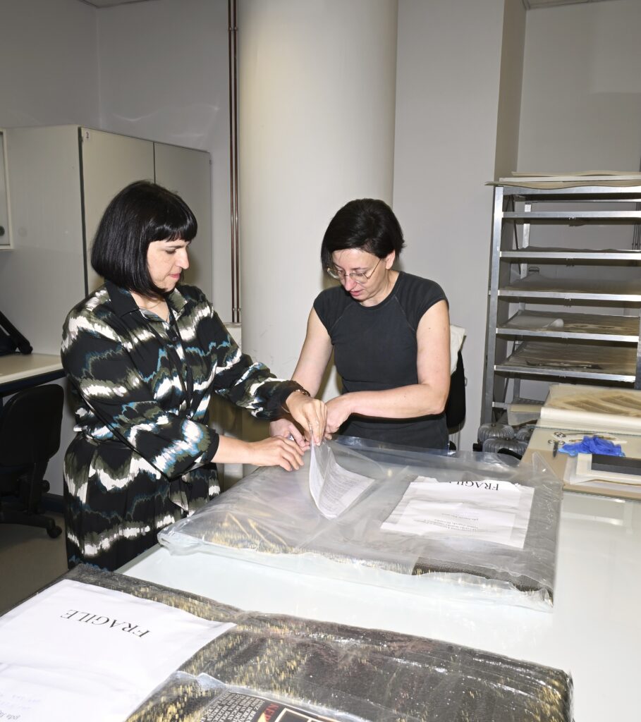 NSK staff unpacking valuable material donated to NSK by Ms Marija Orač.